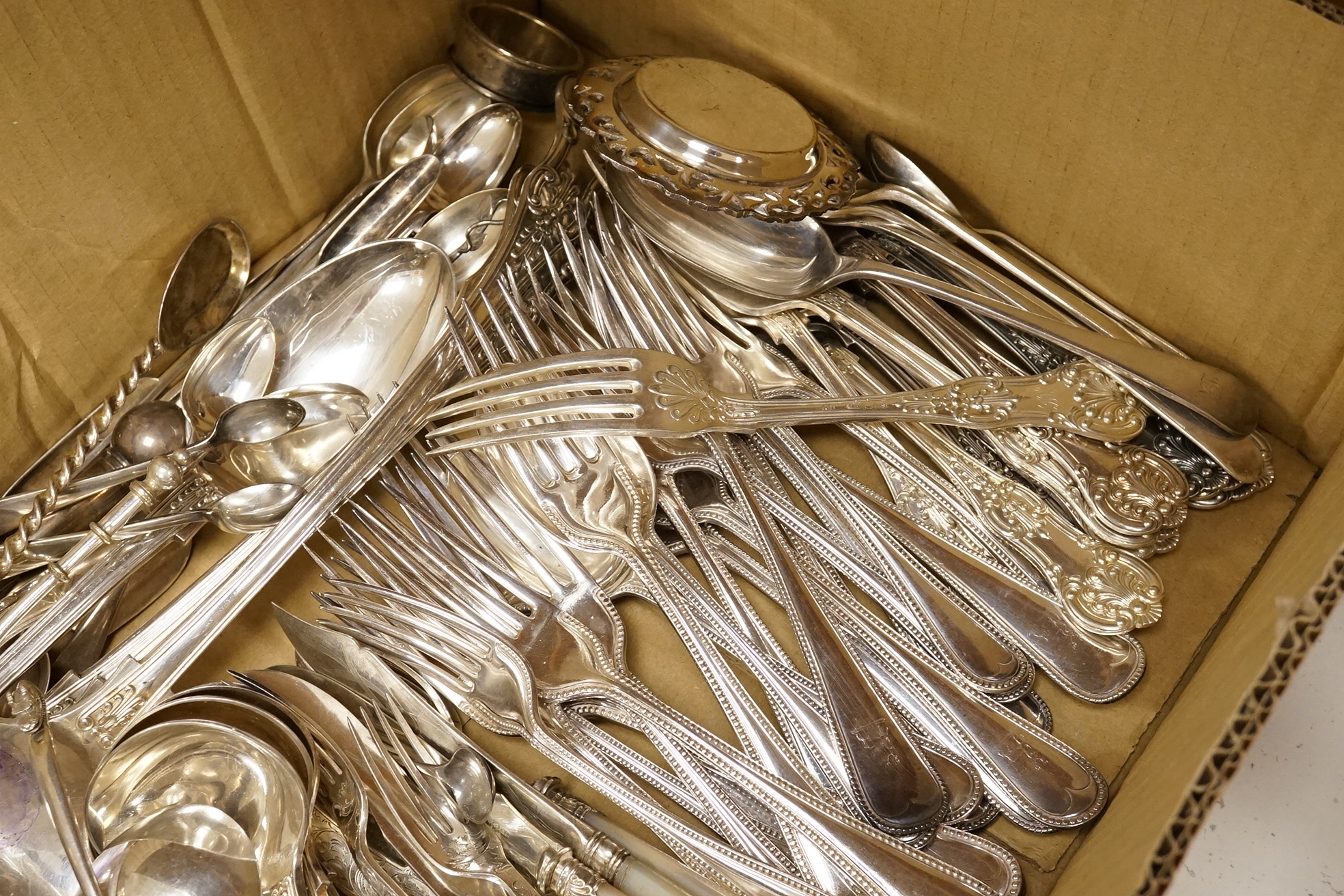 A quantity of assorted plated flatware including Kings pattern and beaded Old English pattern.